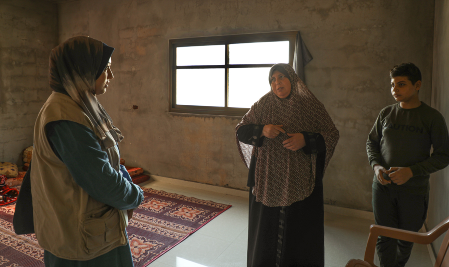 Taghreed and her son telling WFP staff about their story. Photo: WFP/Nour Hammad