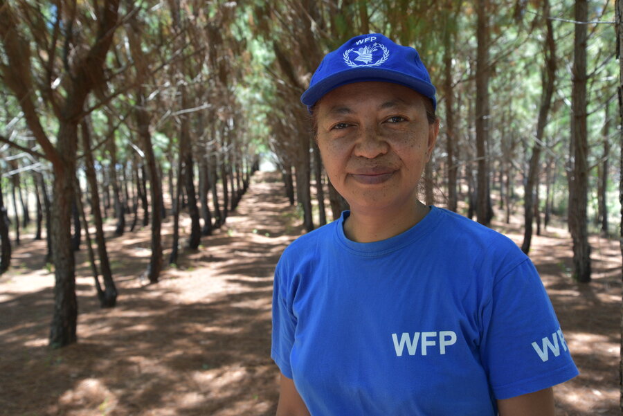 Woman among trees looking at camera