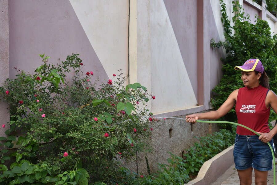 Woman watering plants outside