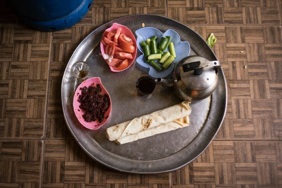 Rokati prepares a rolled sandwich with oil and spices for her son’s lunch, and just a tea for herself.