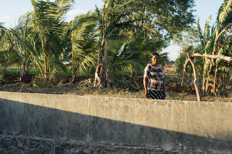 Female farmer next to agro well in Sri Lanka