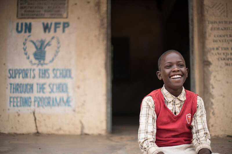 A child from Napumpum Primary School (Uganda) waits for his name to be called to collect his take-home rations. Photo: WFP/Hugh Rutherford