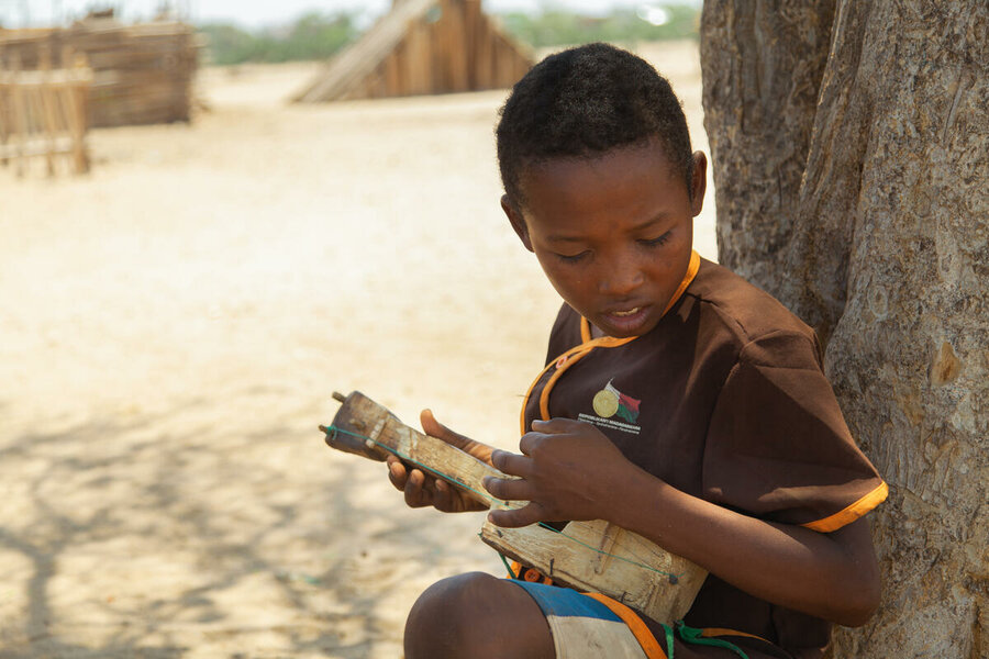 Seraphin playing a mandolin he has built himself