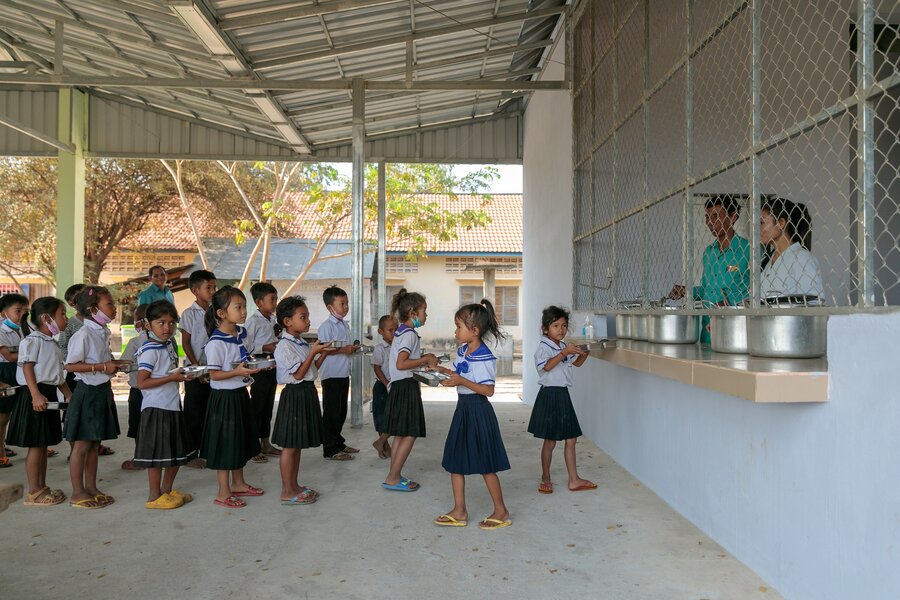 Children line up to collect their meal at school