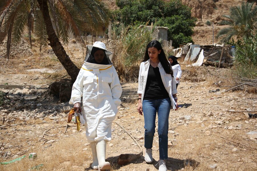 The beehives are a short walk from Aisha's house, where she can easily visit them a few times a week"