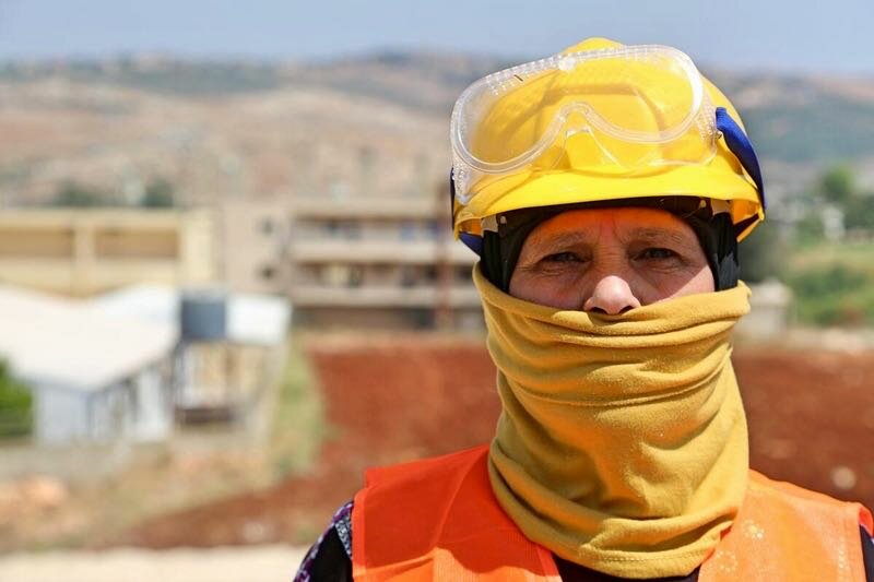 in Lebanon, women like Rafaa receive WFP payments for community work like paving roads.