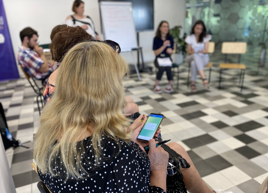People test the ETC ChatBot (vBezpetsi in Ukrainian, which translates to “safe spaces”) on Telegram for the first time, June 2022. Photo: WFP/Beryl Lo.