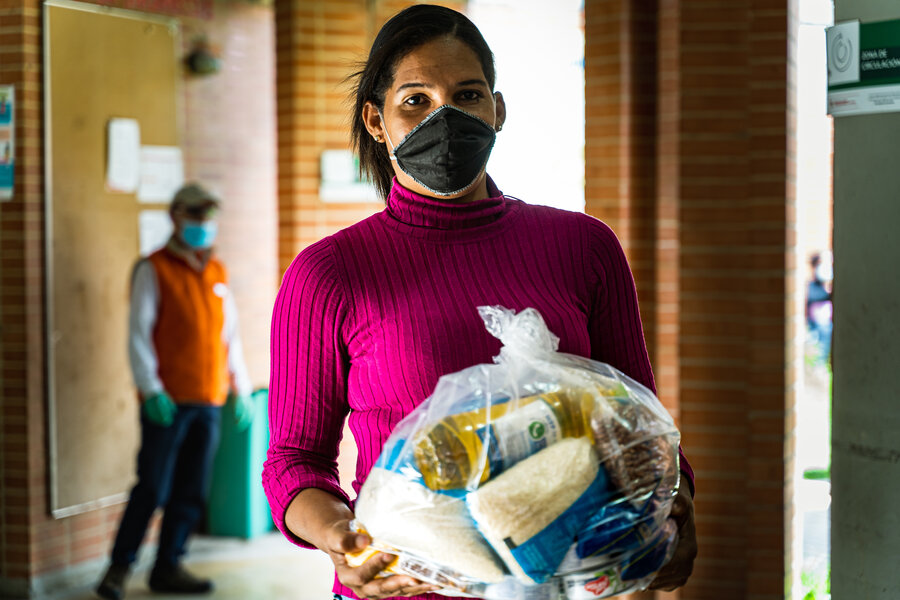 Woman holding bag of food