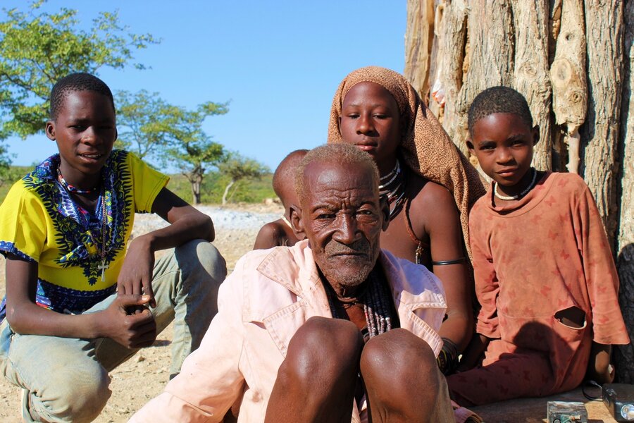 Kavanga with his youngest children outside their home. Photo: WFP/Luise Shikongo