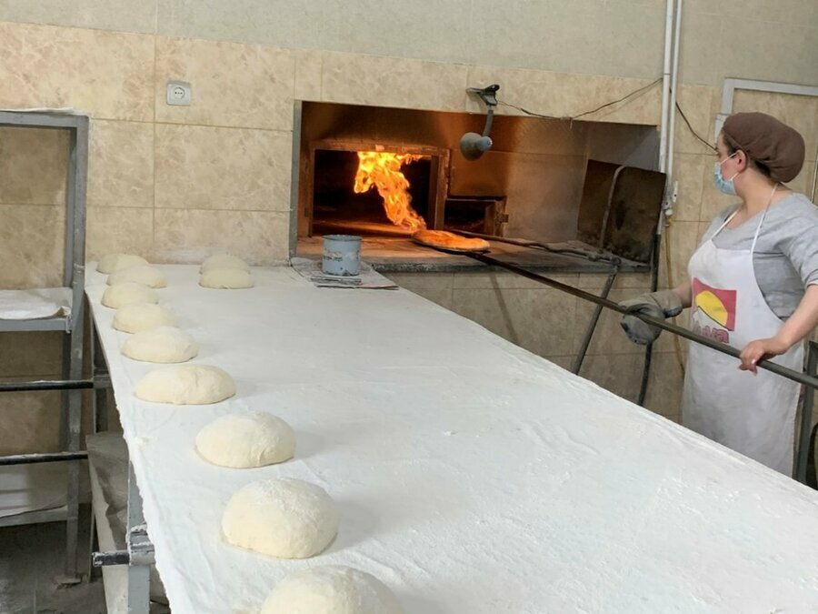 Preparing bread in a solar-powered baking in Armenia.