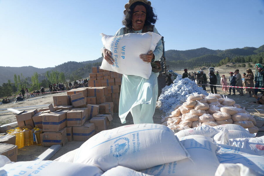 A man loads WFP food into trucks to assist earthquake-affected families in June. Photo: WFP/Sadeq Naseri 