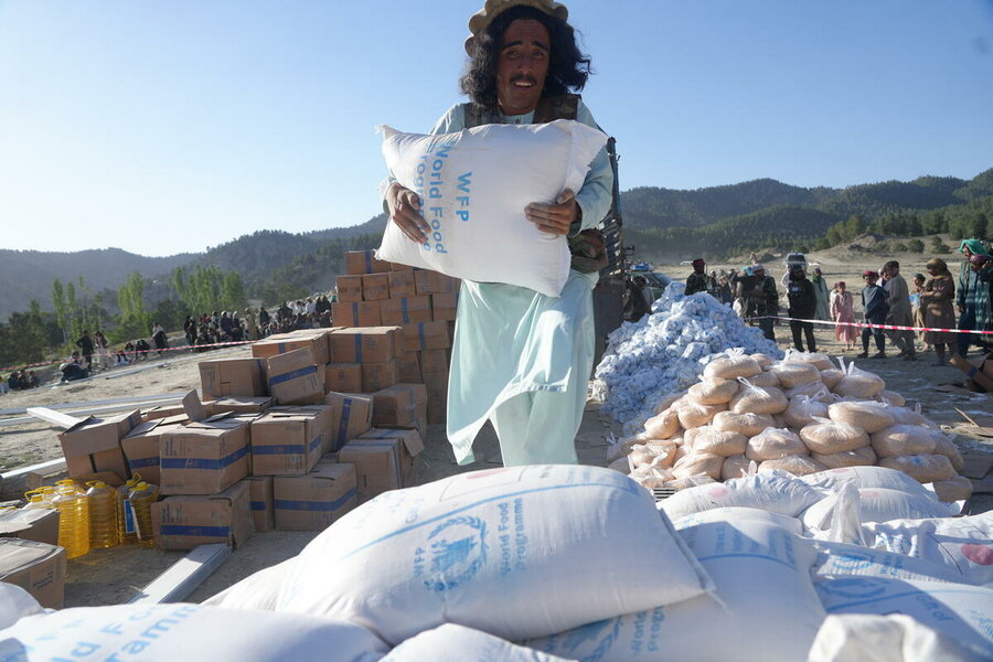 A man loads WFP food into trucks to assist earthquake-affected families in June. Photo: WFP/Sadeq Naseri