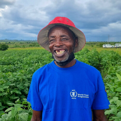a man, wearing a WFP t-shirt, is smiling to camera 