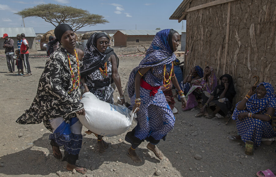 Women carrying a bag of food
