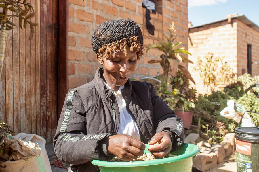 Grace shells groundnuts she grew with WFP's support. Photo: WFP/Christopher Katete