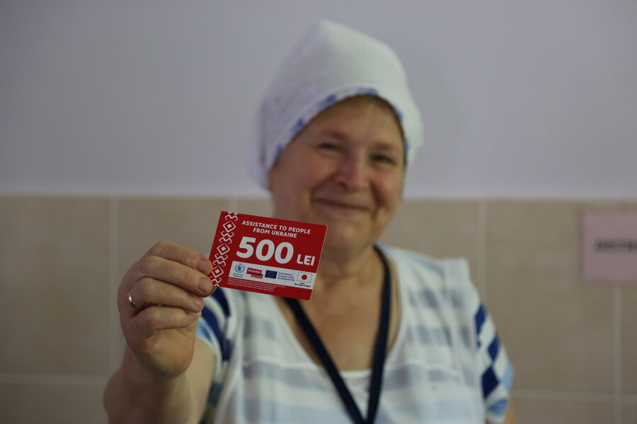 Kitchen Manager Tatiana holds a WFP commodity voucher used to purchase food for the centre at local grocery stores. Photo: WFP/Kyle Wilkinson
