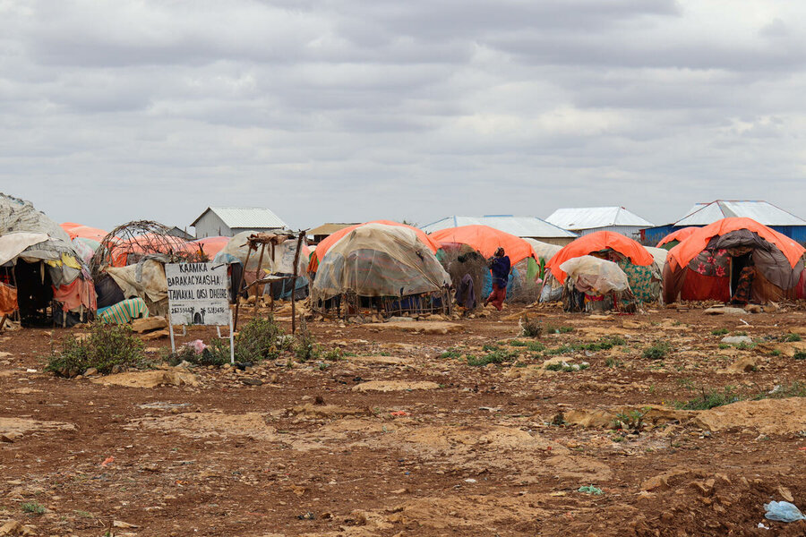 Residents of a camp on the outskirts of Baidoa receive support from WFP