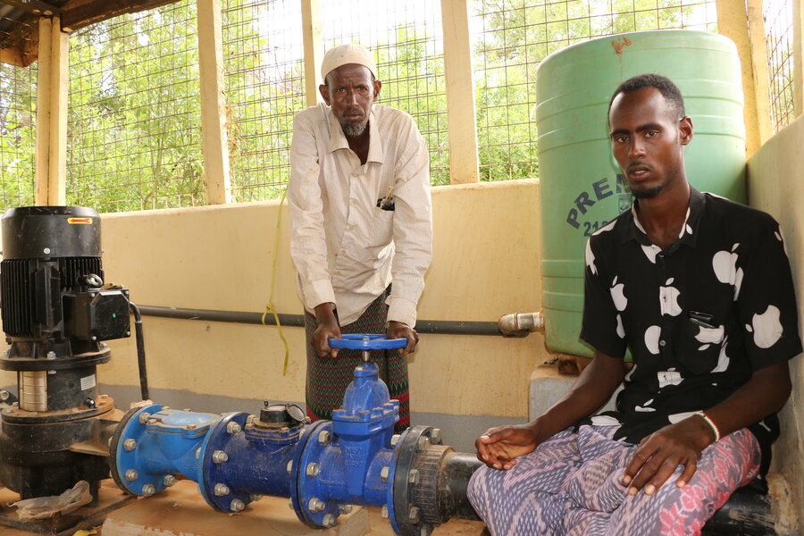 Abdi Raman (R) at the water pumping station in Garissa. Photo: WFP/Martin Karimi