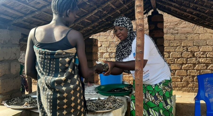 Garcia selling dry fish to a customer