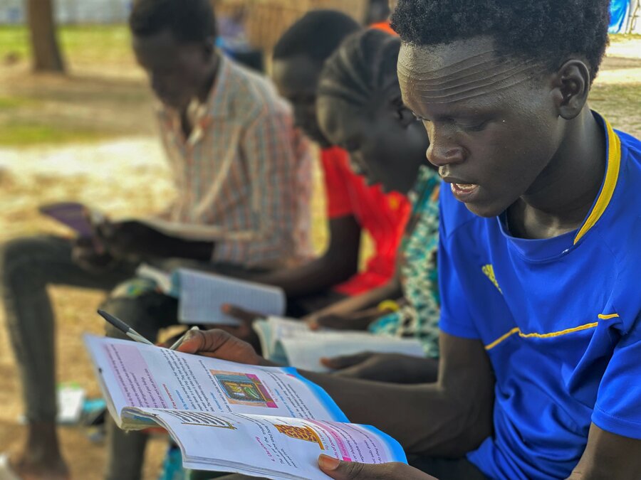 Students aged 18 and 21 study food waste in an open-air classroom. Photo: WFP/Marwa Awad