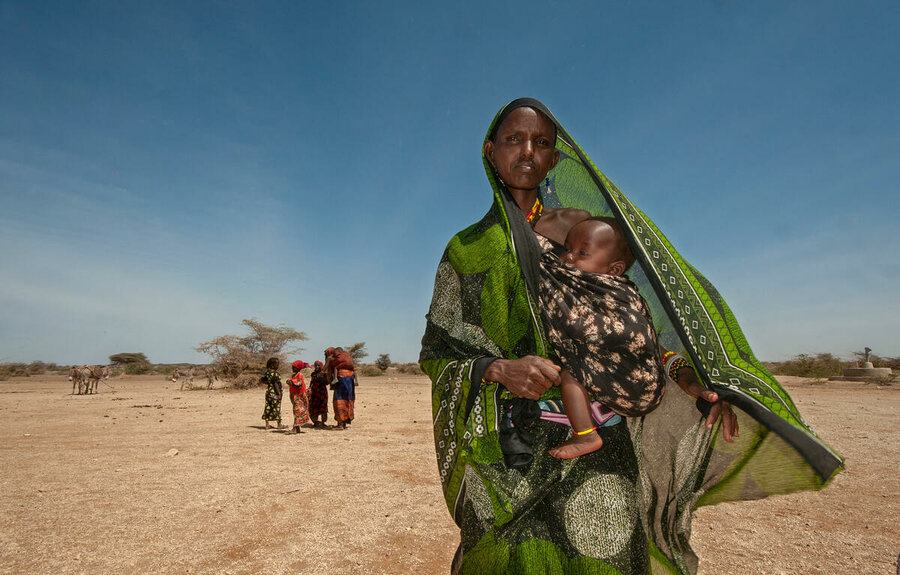 Robe Denge and her baby wait at a WFP general food distribution point in the village of Malabot in Marsabit County in northern Kenya. Millions of people in the Horn of Africa are affected by a severe drought caused by five consecutive failed rainy seasons. Photo: WFP/Alessandro Abbonizio
