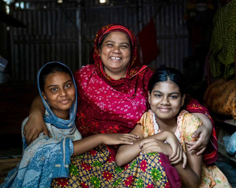 Mother and daughters in project supported by blockchain in Bangladesh smile in posed shot