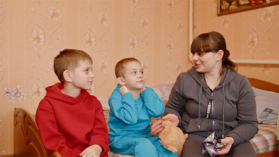 Alyona with two of her children. They are back in school but the family's future is uncertain. Photo: WFP/Serhii Artemov