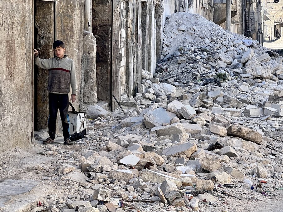 A boy in rubble in a town in Syria