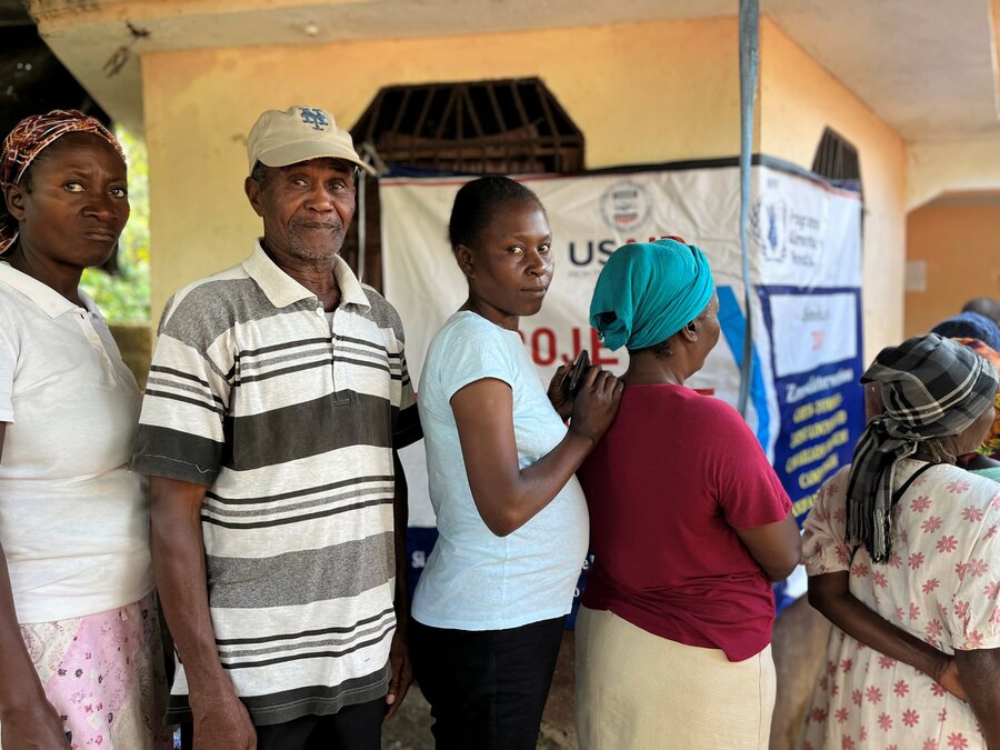 People wait in line for cash near Les Cayes in Haiti