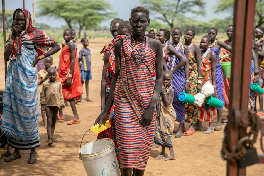 Nari receives WFP food assistance for the first time at a distribution site in Riwoto, Kapoeta North