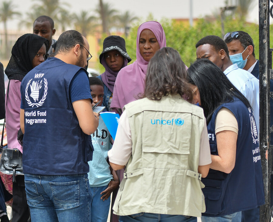 People arriving from Sudan are greeted by UN staff in Egypt