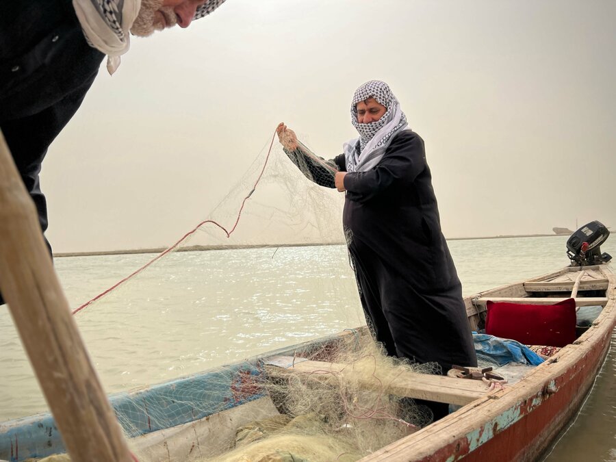 Hakim (Abu Youssef – the father of Youssef) has been a fisherman his entire life. He patiently untangles his net as he tells WFP where the waters have taken him. Photo: WFP/Edmond Khoury
