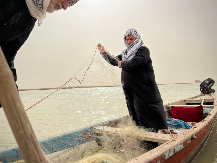 Hakim (Abu Youssef - the father of Youssef) has been a fisherman his entire life. He patiently untangles his net as he tells WFP where the waters have taken him. Photo: WFP/Edmond Khoury