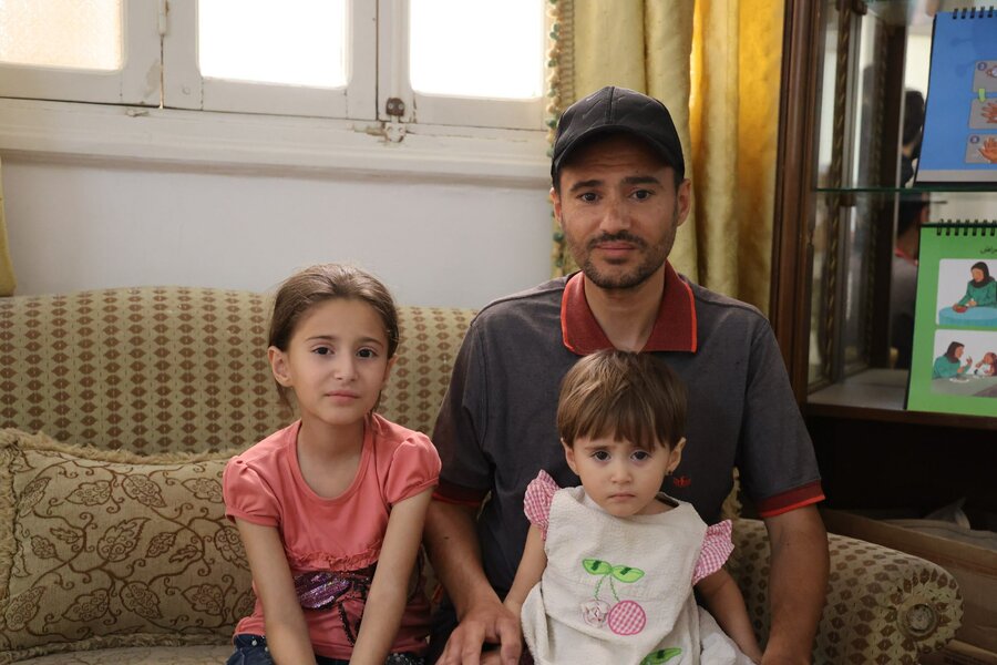 Maher and his daughters in Deir Azzor, Syria - the family are feeling the brunt of food shortages