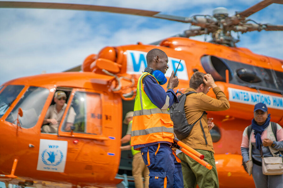 Orange-coloured chopper operated by WFP for UNHAS