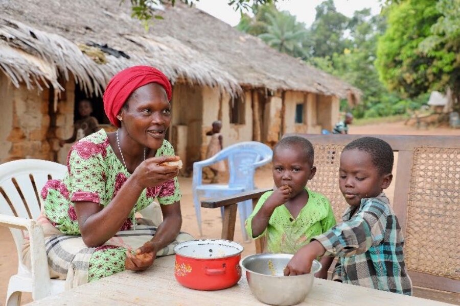 Gentille and her children tuck into a nutrition-packed meal at Inke village. Findings show the WFP-supported nutrition cooking classes have helped to diversify Congolese diets. Photo: WFP/Hedley Tah