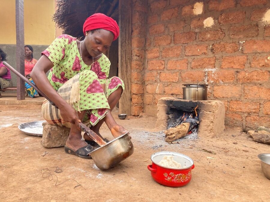 Gentille prepares nutrient-packed pondu, a local dish, for her children, using tips from the cooking classes. Photo: WFP/Hedley Tah