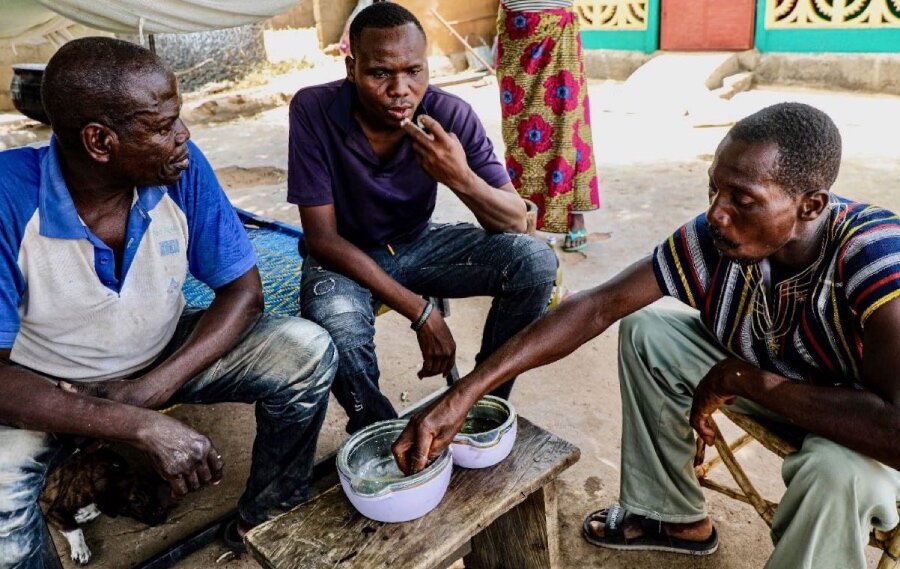 Probate (M) shares a meagre meal with his Togolese relatives who have offered him refuge. Photo: WFP/Richard Mbouet