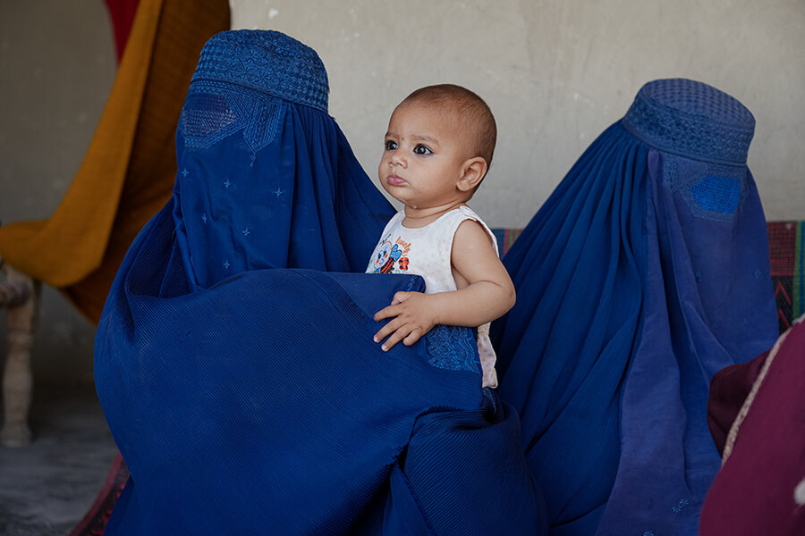 Women in burqas with a child in Kabul city