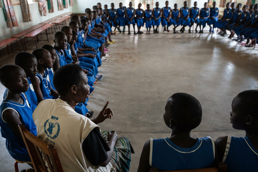 WFP Programme Associate Joyce Namoe talks to girls at the Kangole Girls Primary School in Kangole, Uganda. Photo: WFP/Arete/Siegfried Modola