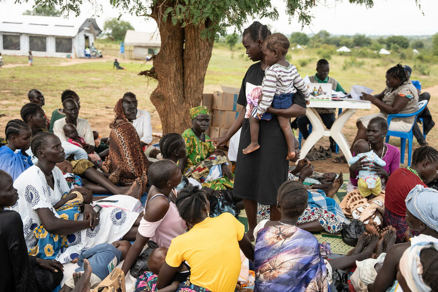 Christine stands among other mothers while sharing breastfeeding tips