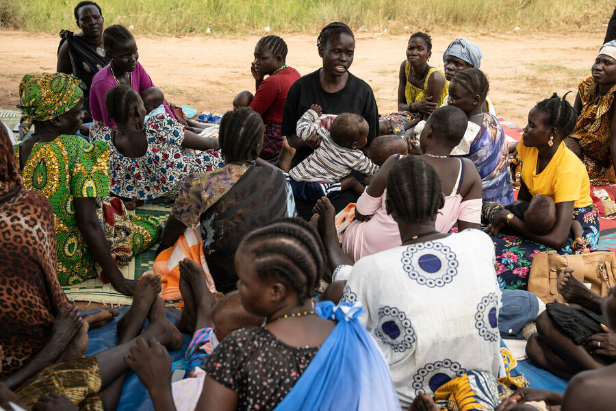 Christine speaks with other mothers, sharing breastfeeding knowledge