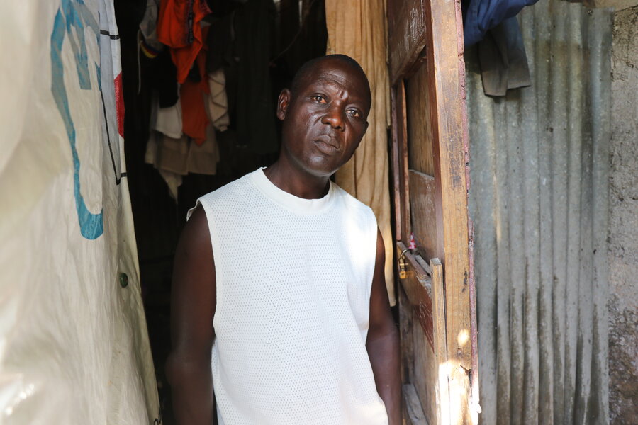 At a makeshift camp in Haiti's capital Port-au-Prince, Herman Petitfrere scrounges just to find water. Photo: WFP/Pedro Rodrigues