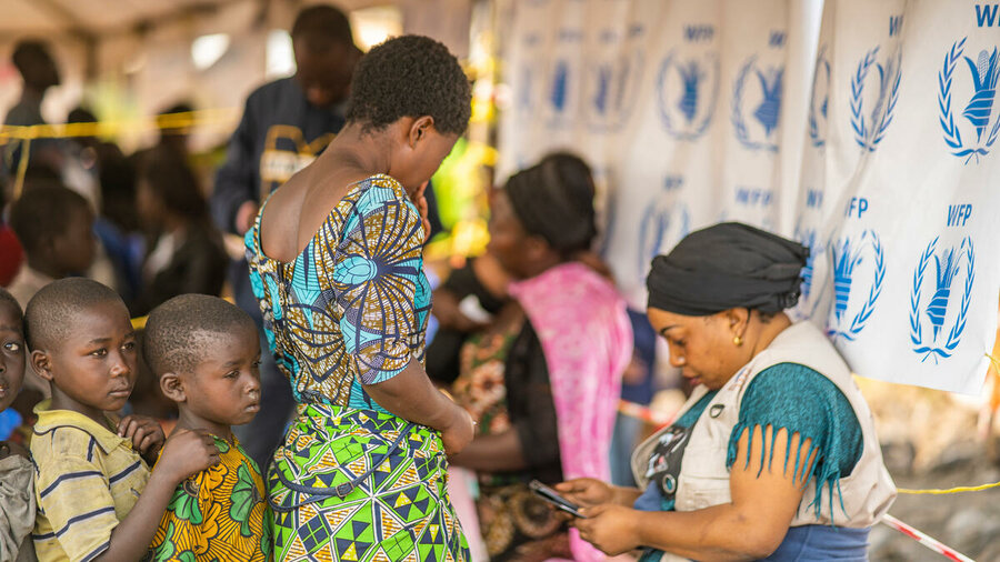 A woman receives cash assistance in Rusavo, in DRC's eastern North Kivu province. Photo: WFP/Michael Castofas