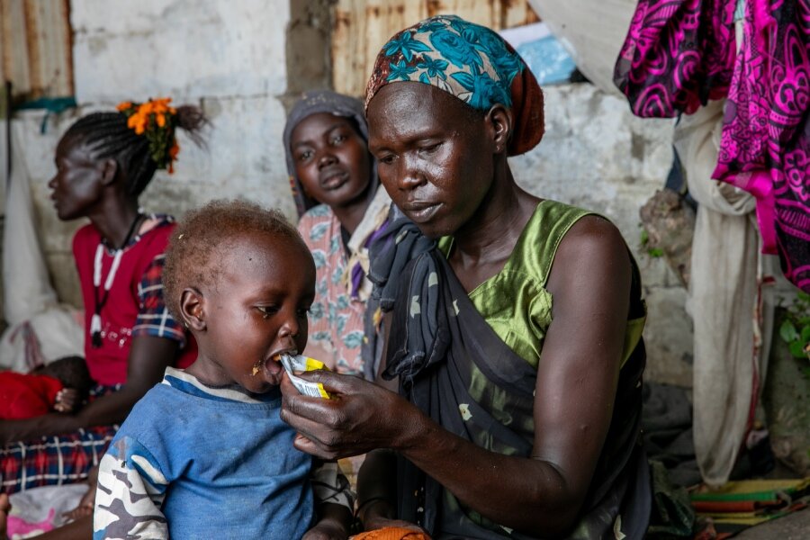 Aker Monychol Biar feeds her son a special food supplement to treat malnutrition. Photo: WFP/Eulalia Berlanga