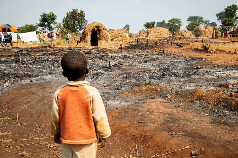 A boy gazes at the fire-wrought damage of a camp for conflict-displaced people in South Kivu province, DRC, where WFP provides food assistance. Photo: WFP/Michael Castofas