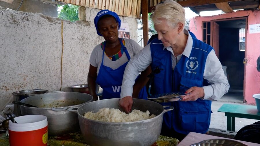 WFP Executive Director Cindy McCain (R) helps dish up school meals during a visit to Haiti. The country's hunger crisis is "unseen, unheard and unaddressed," she says. Photo: WFP/Julian Civiero
