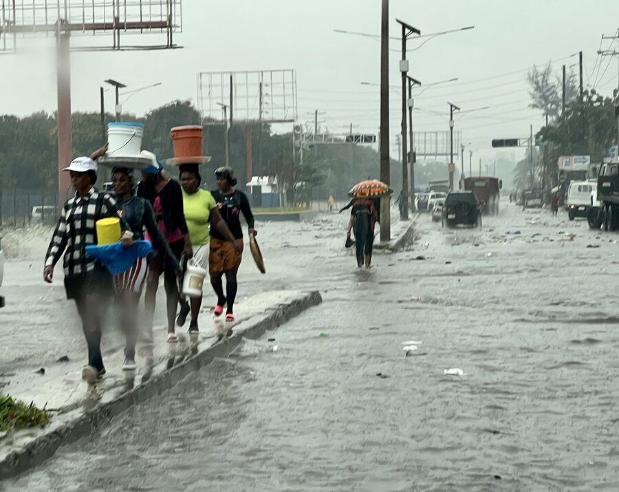 People walking through flooded streets