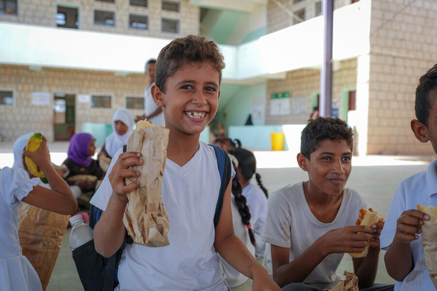 These schoolboys enjoying lunch at Al-Emad school in Aden, Yemen, count among some 20 million kids in 74 countries enjoying WFP-supported school meals. Photo: WFP/Alaa Noman