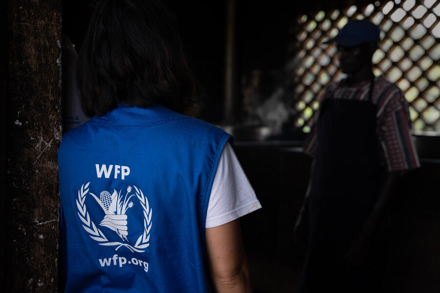 A WFP humanitarian worker talks to kitchen staff at a school Namalu, Karamoja, Uganda 